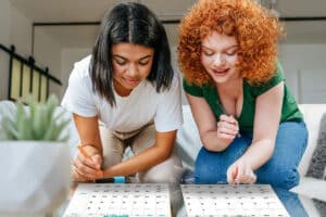 2 women writing in calendars at a calendar exchange party