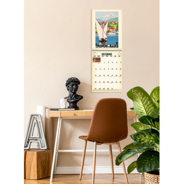 Photo showing the Asgard Press 2026 Vintage Travel Posters Calendar hanging on a wall over a desk
