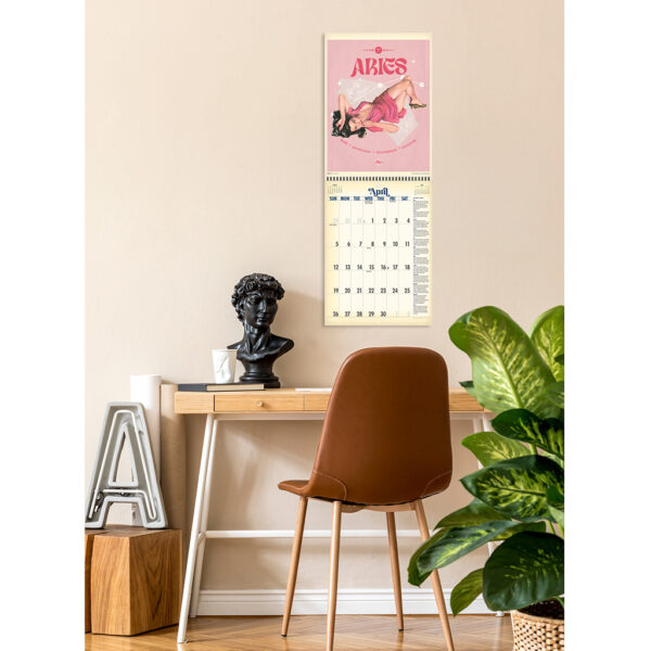 Photo showing the Asgard Press 2026 Retro Zodiac Pinups Calendar hanging over a desk