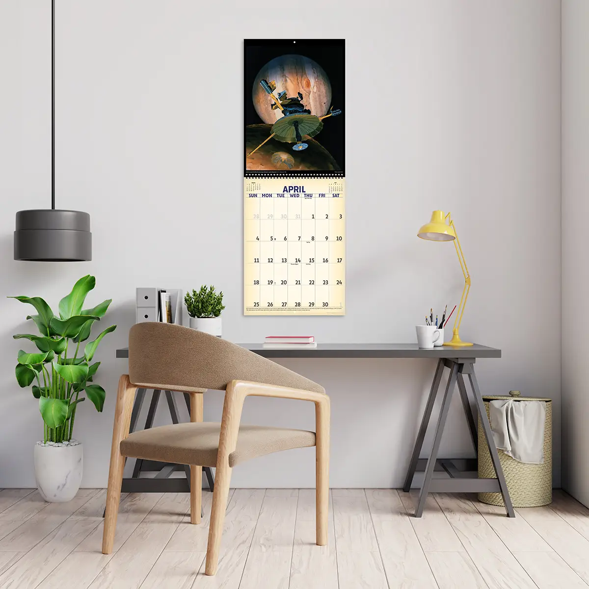 2027 Vintage Art of Space Deluxe Calendar hanging above a desk