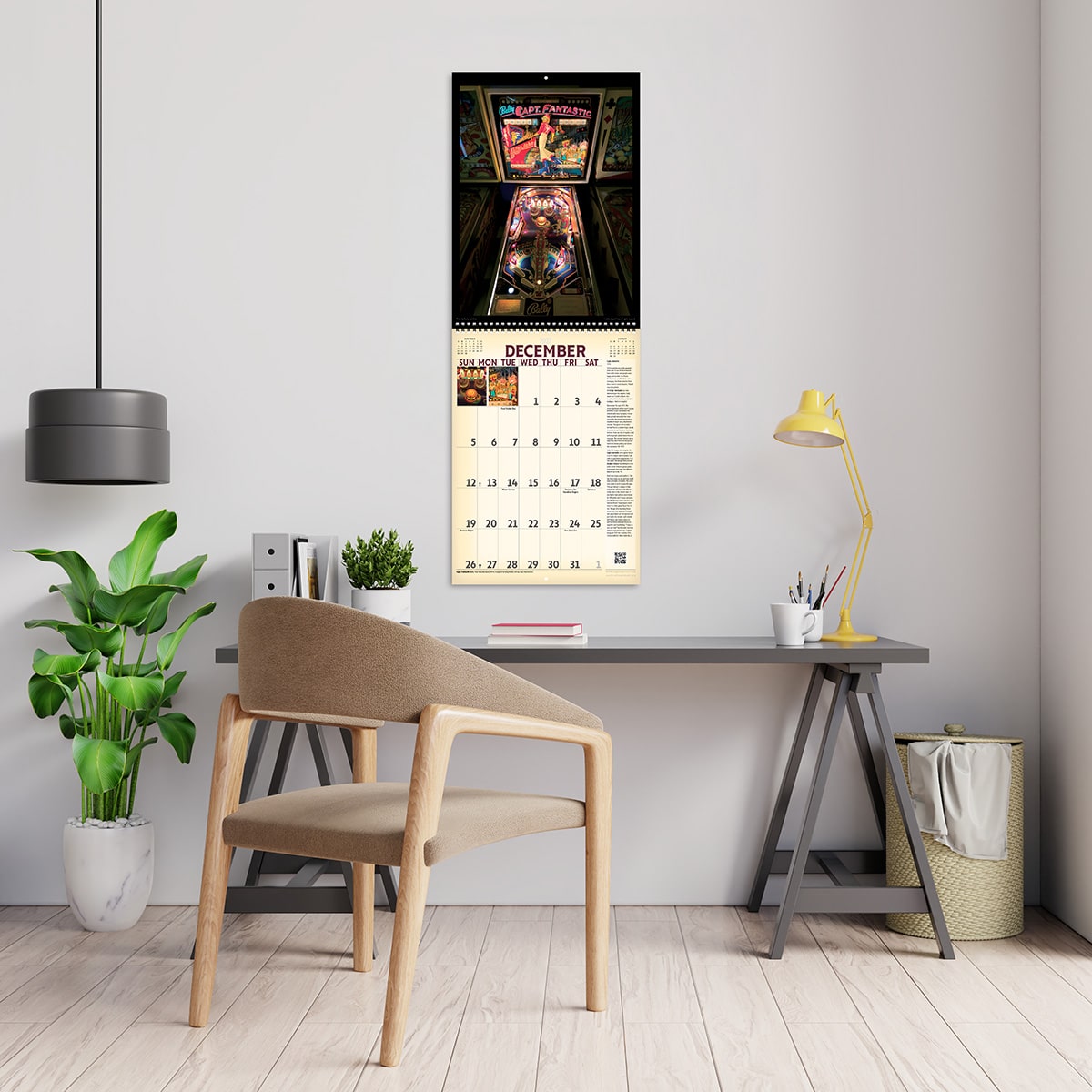 2027 Vintage Pinball Deluxe Calendar hanging above a desk