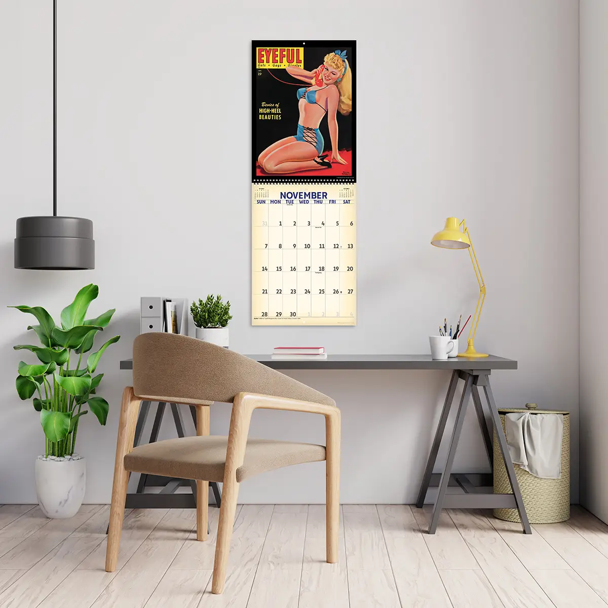 2027 Vintage Pinups Deluxe Calendar hanging above a desk