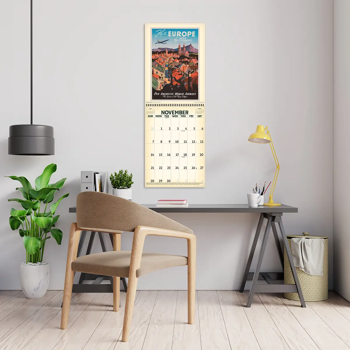 2027 Vintage Travel Posters Deluxe Calendar hanging above a desk