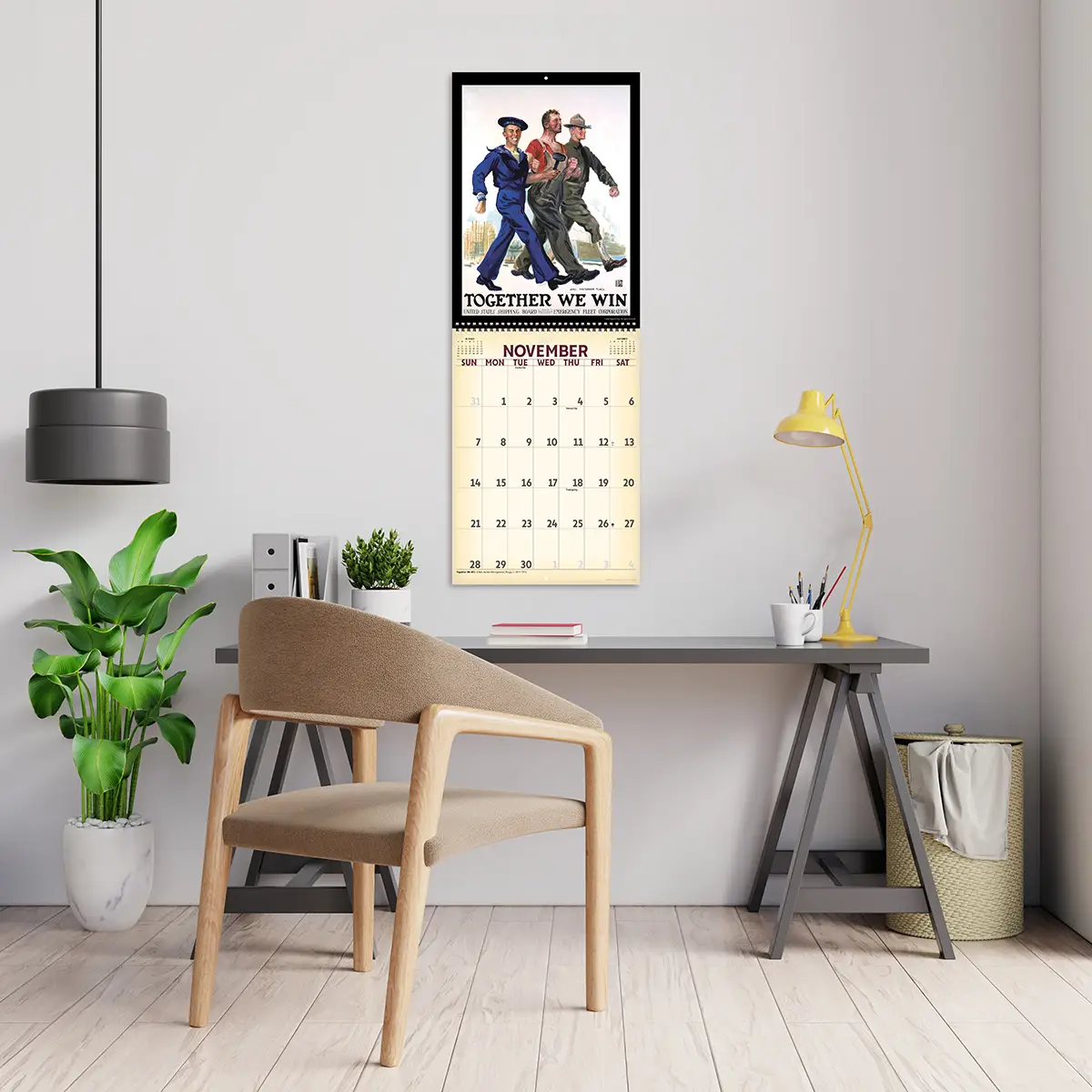2027 Vintage War Posters Deluxe Calendar hanging above a desk