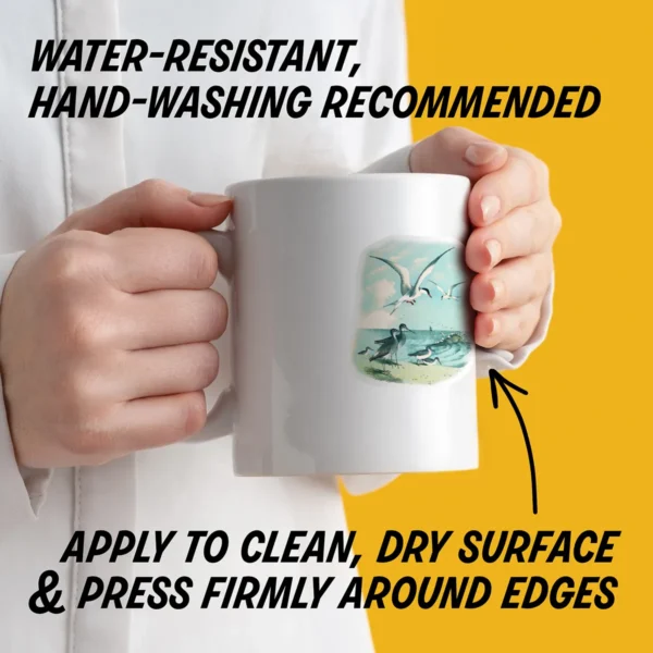 Water-resistant sticker on a mug with instructions to apply to a clean, dry surface, press edges firmly, and hand wash decorated items.