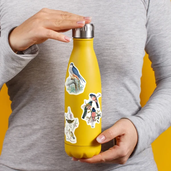 A sampling of stickers from the Vintage Birds sticker set stuck on a water bottle