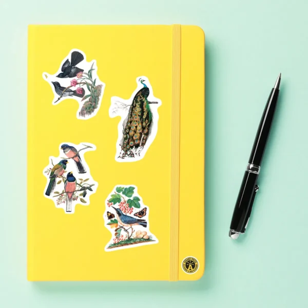 A sampling of stickers from the Vintage Birds sticker set stuck on a notebook