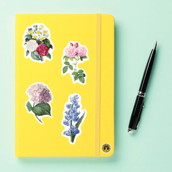 A sampling of stickers from the Vintage Botanicals sticker set stuck on a notebook