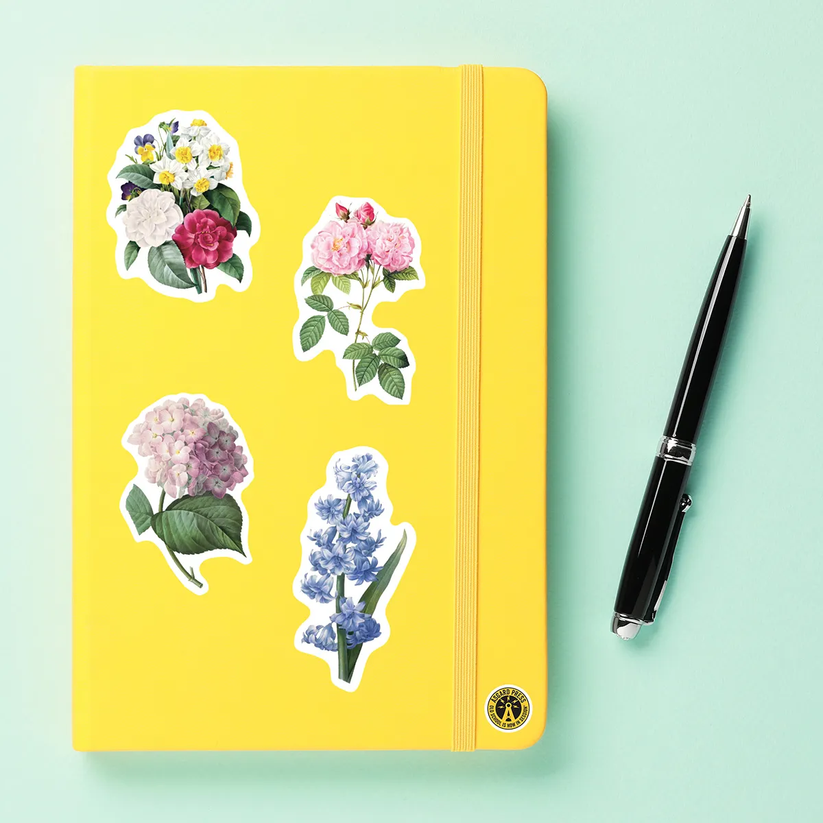 A sampling of stickers from the Vintage Botanicals sticker set stuck on a notebook