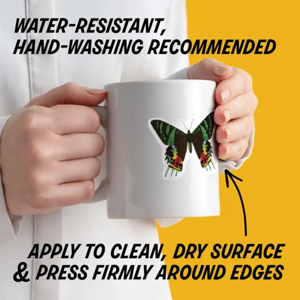 Water-resistant sticker on a mug with instructions to apply to a clean, dry surface, press edges firmly, and hand wash decorated items.