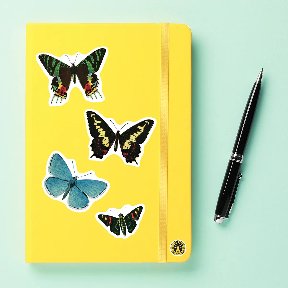A sampling of stickers from the Vintage Butterflies sticker set stuck on a notebook