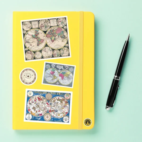 A sampling of stickers from the Vintage Maps sticker set stuck on a notebook