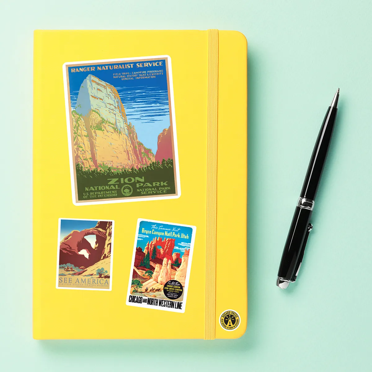 A sampling of stickers from the Vintage National Park Posters sticker set stuck on a notebook