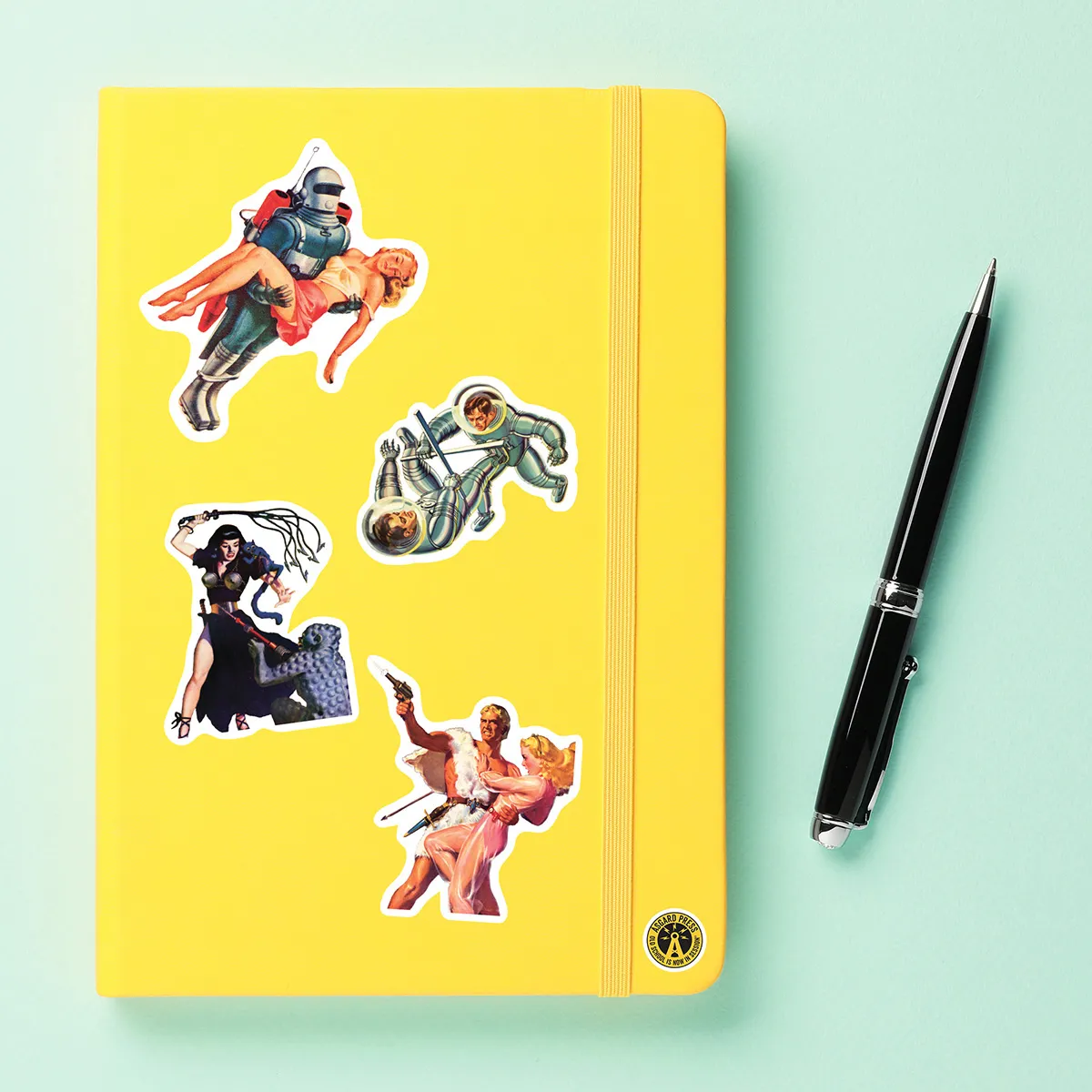 A sampling of stickers from the Vintage Sci-Fi Art sticker set stuck on a notebook