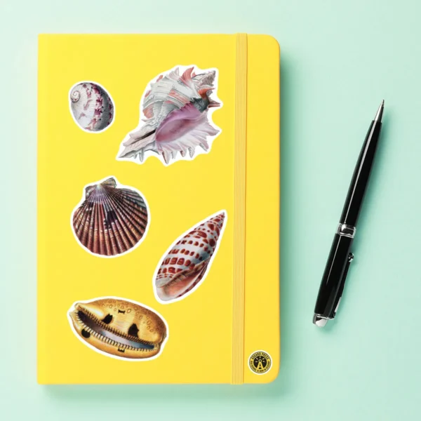 A sampling of stickers from the Vintage Sea Shells sticker set stuck on a notebook