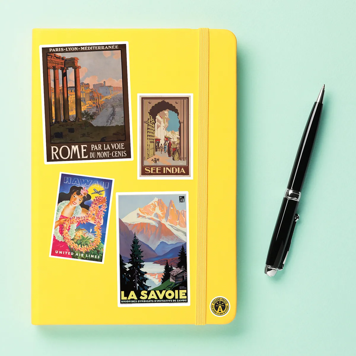 A sampling of stickers from the Vintage Travel Posters sticker set stuck on a notebook