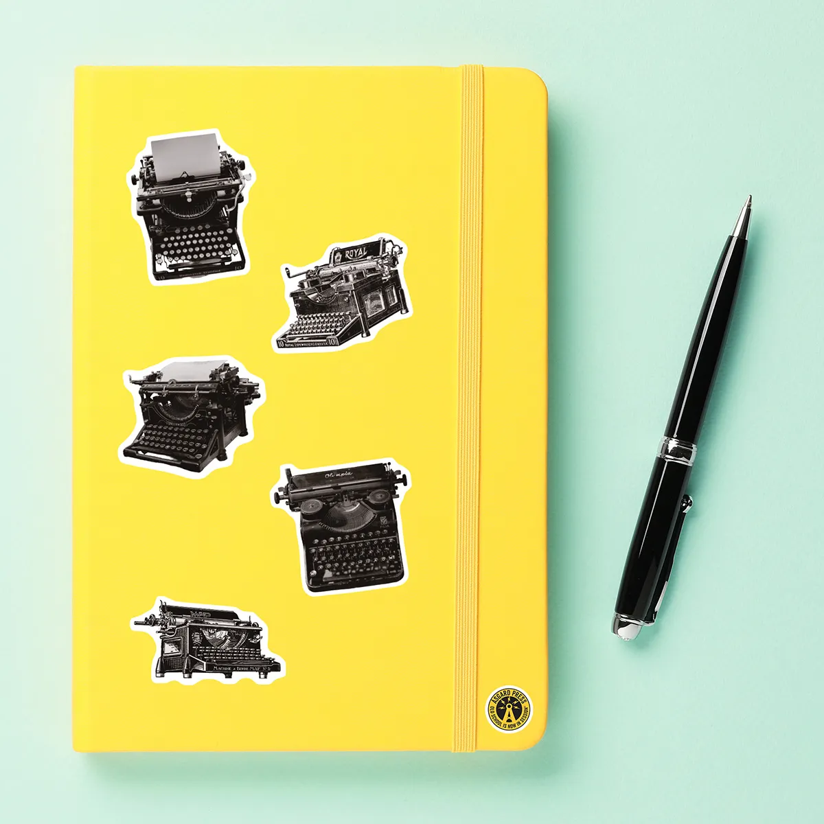 A sampling of stickers from the Vintage Typewriters sticker set stuck on a notebook